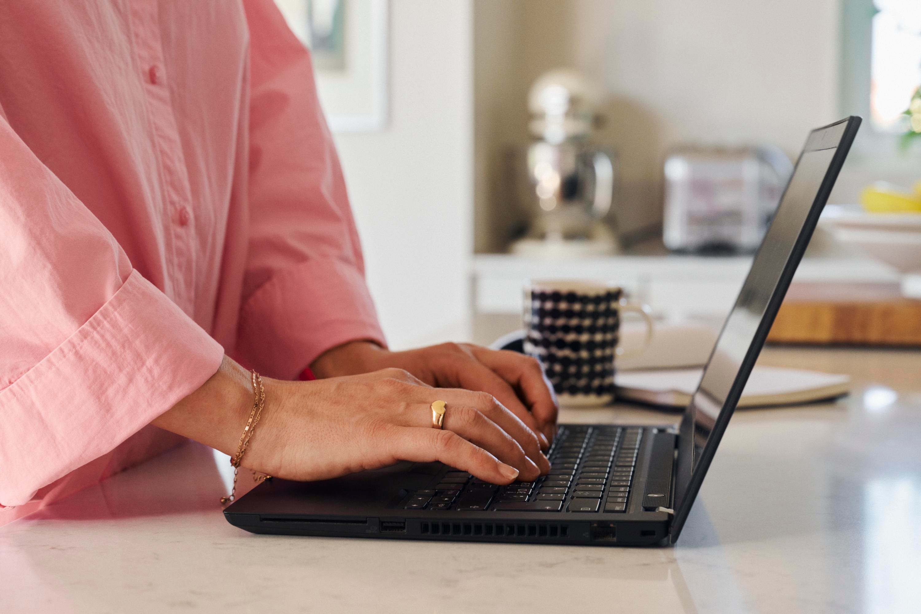 Close up on a person working on their laptop
